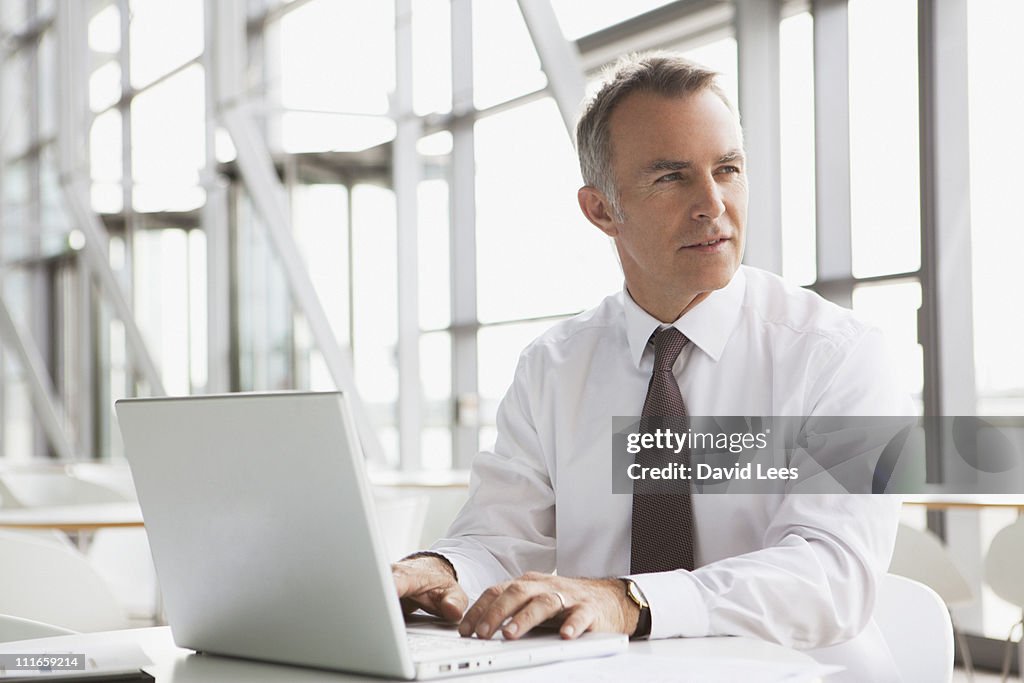 Businessman using laptop in office