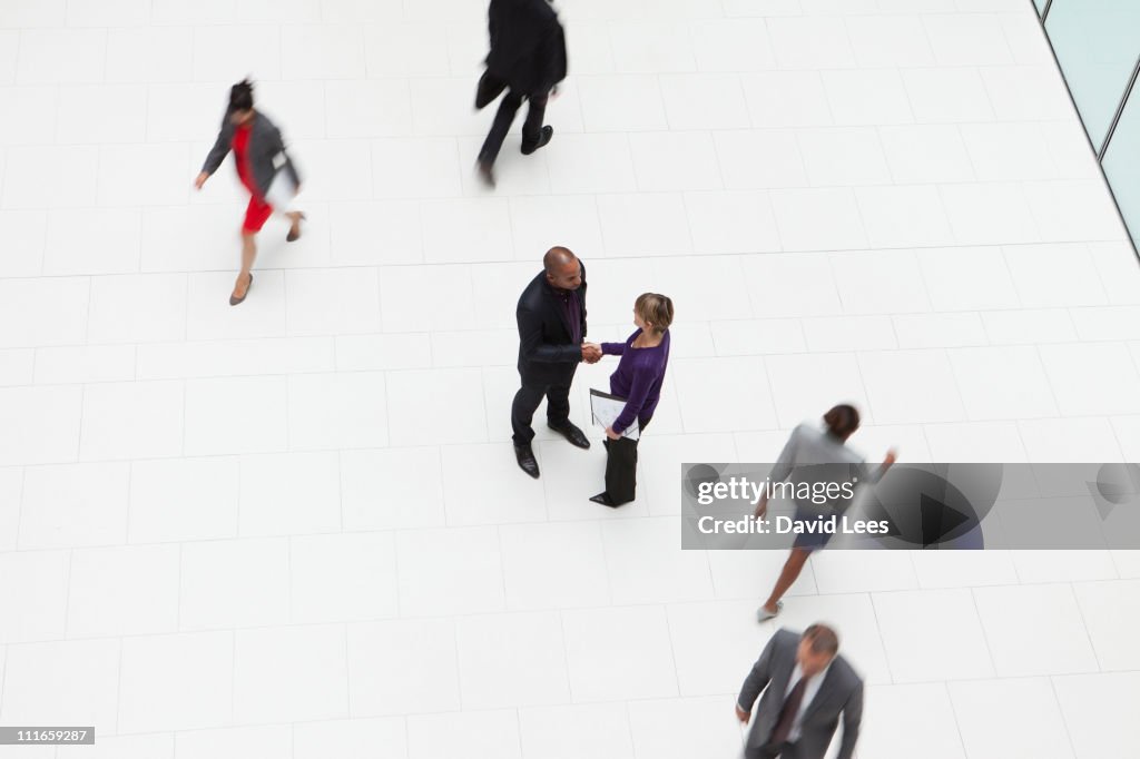 Businessman and businesswoman shaking hands