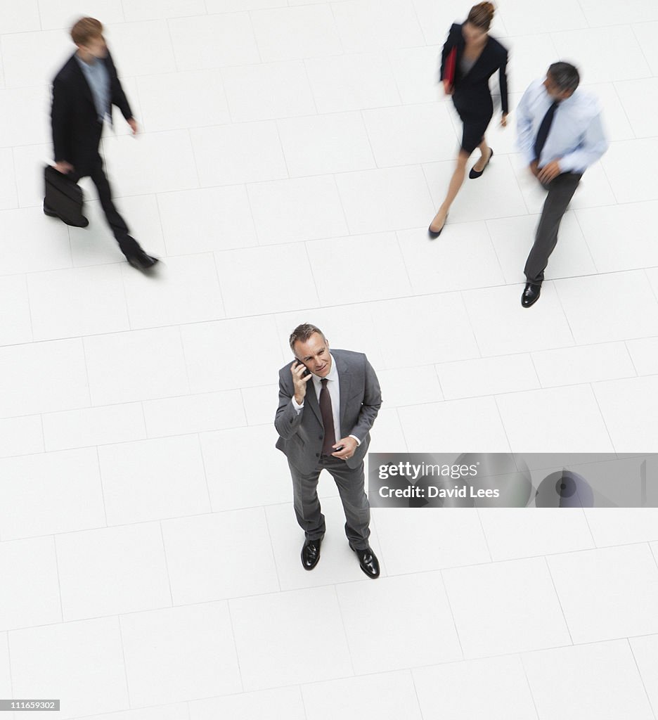 Businessman using mobile, overhead view