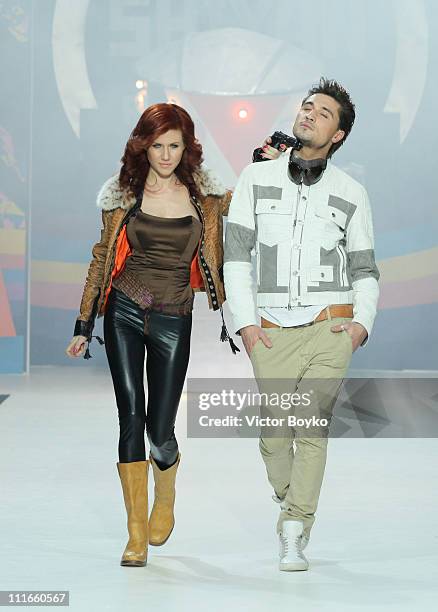 Anna Chapman and singer/model Dima Bilan walk on the runway during the Shiyan & Rudkovskaya show at Moscow Fashion Week on April 04, 2011 in Moscow,...