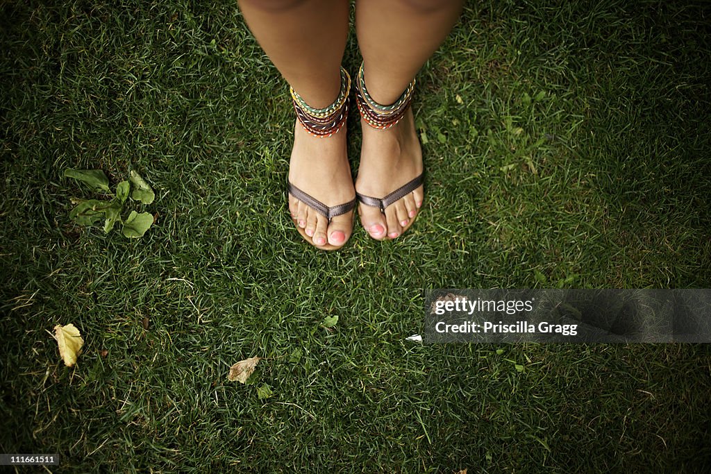 Hispanic woman wearing anklets and sandals