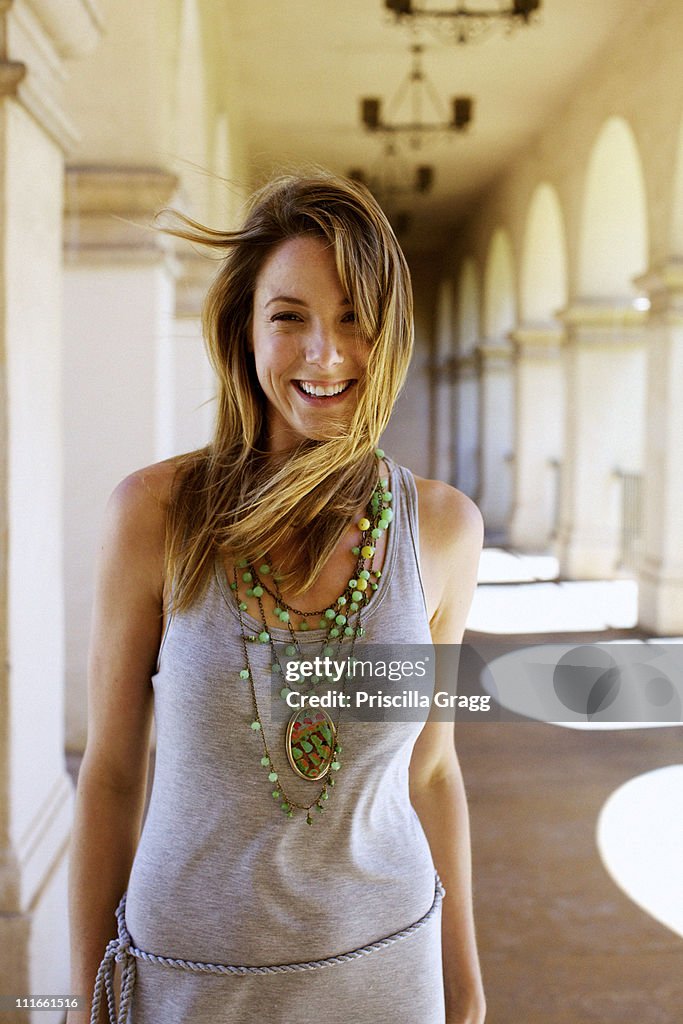 Smiling Caucasian woman standing in portico