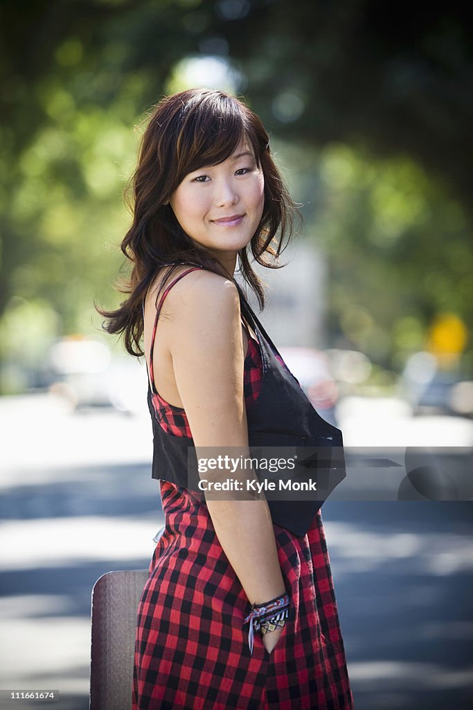 Smiling Korean woman standing outdoors