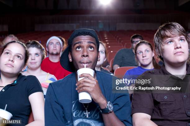 friends watching movie in theater - kinosaal stock-fotos und bilder