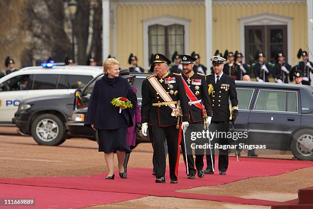 Lithuania's President Dalia Grybauskaite and King Harald V of Norway attend the official welcoming ceremony at the Royal Palace on the first day of...