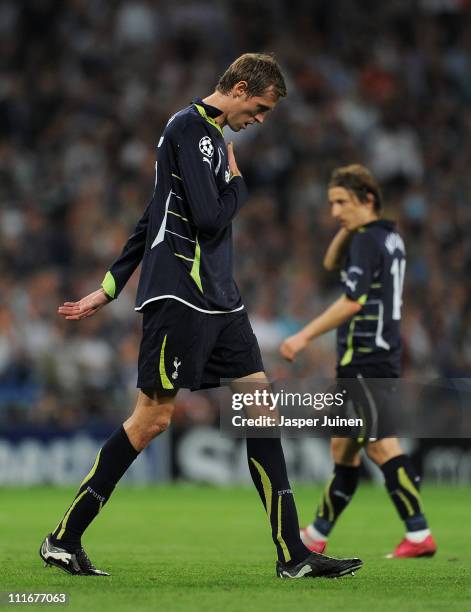 Peter Crouch of Tottenham Hotspur trudges off the pitch backdropped by his teammate Luka Modric during the UEFA Champions League quarter final first...
