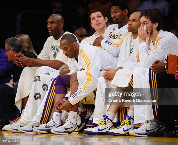 Kobe Bryant of the Los Angeles Lakers ties up his shoe laces during the game against Denver Nuggets at Staples Center on April 3, 2011 in Los...