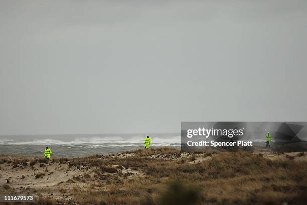 Suffolk County Police and police recruits search an area of beach near where police recently found human remains on April 5, 2011 in Babylon, New...