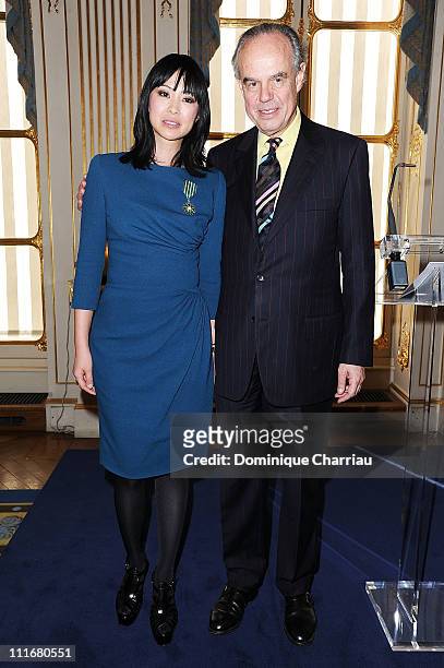 Linh-Dan Pham and French Minister of Culture Frederic Mitterrand pose after she receives the medal "Chevalier des Arts et des lettres" at Ministere...