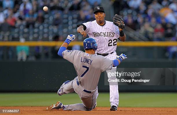 Second baseman Jose Lopez of the Colorado Rockies turns a double play on James Loney of the Los Angeles Dodgers on a grounder by Juan Uribe of the...