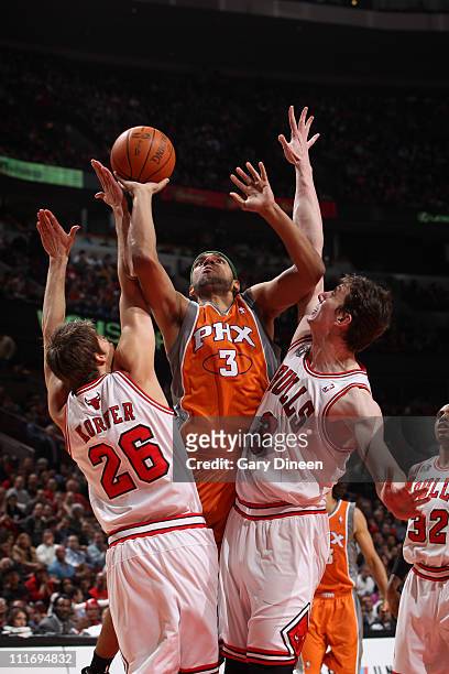 Jared Dudley of the Phoenix Suns shoots against Kyle Korver and Omer Asik of the Chicago Bulls on April 5, 2011 at the United Center in Chicago,...