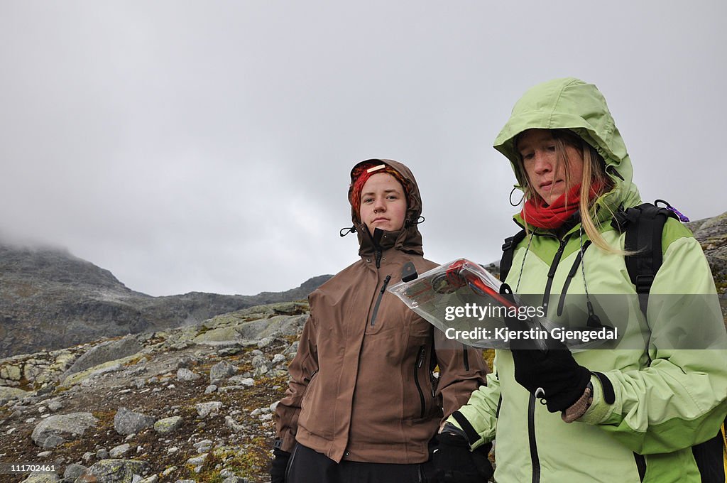 Two women on hike consulting a map