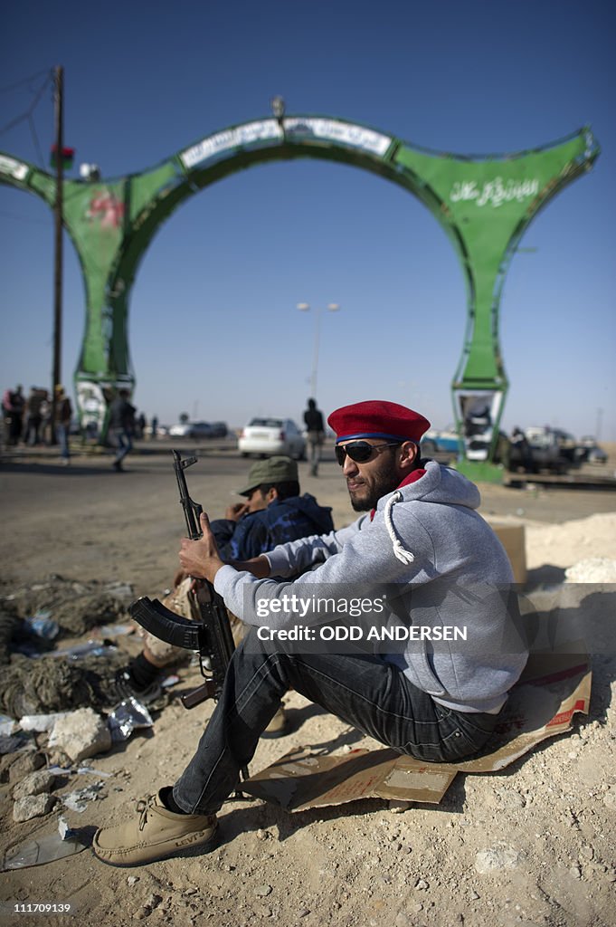 Rebel fighters sits by the western entra