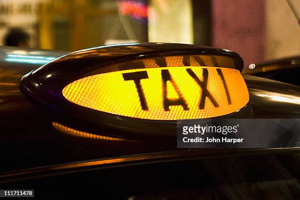 illuminated, taxis sign, london - london taxi ストックフォトと画像