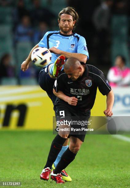 Stephan Keller of Sydney competes for the ball against Salmeron of Shanghai during the group H ACF Champions League match between Sydney FC and...