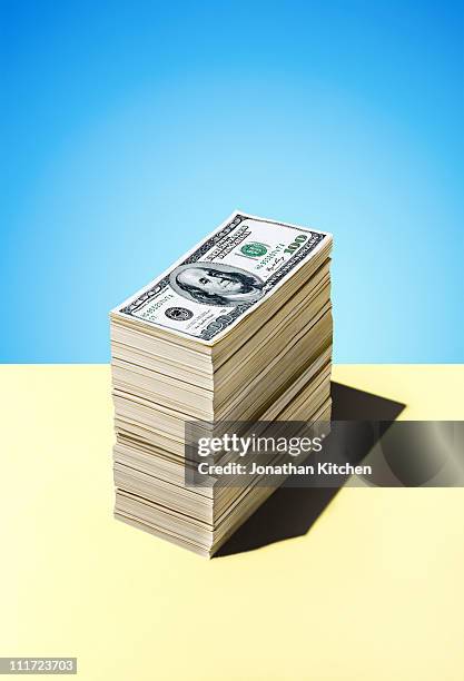 stack of dollar bills - us 100 dollar bills stock pictures, royalty-free photos & images