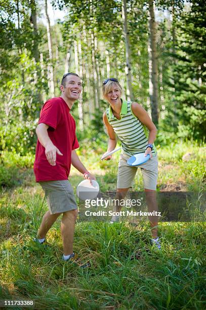 man and woman playing disc golf, park city, utah. - disc golf stock pictures, royalty-free photos & images
