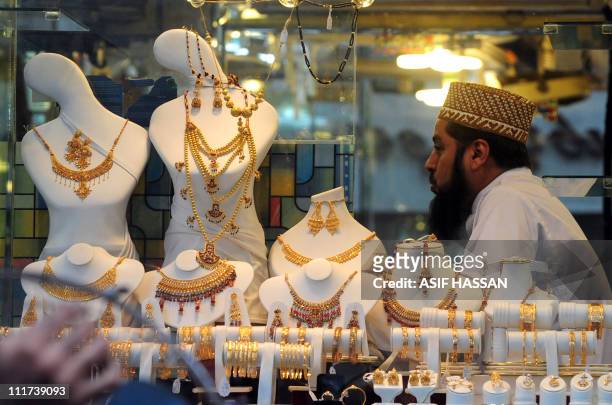 Pakistani jeweler waits for customers at his shop in Karachi on April 6, 2011. The gold prices have touched a historic high with 46,650 Pakistani...