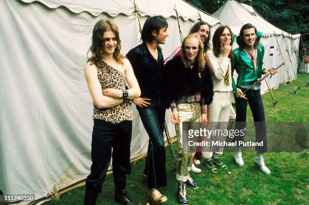 Roxy Music posed backstage at the Crystal Palace Garden Party in Crystal Palace park, London on 29th July 1972. L-R Paul Thompson, Bryan Ferry, Brian...