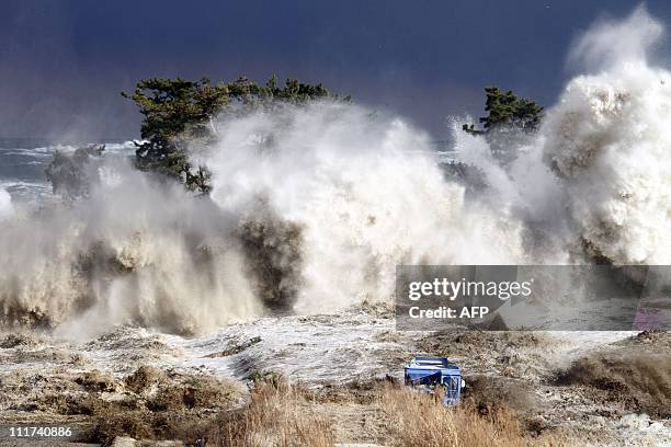 This picture taken on March 11, 2011 by Sadatsugu Tomizawa and released via Jiji Press on March 21, 2011 shows tsunami waves hitting the coast of...