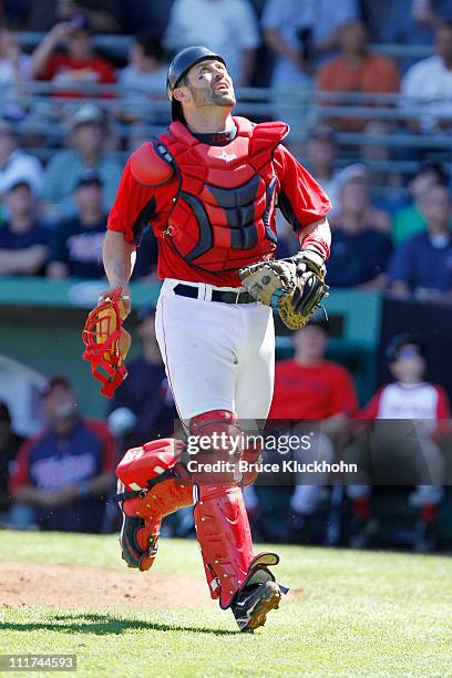 Jason Varitek of the Boston Red Sox looks to a pop foul in the game against the Minnesota Twins in Spring Training February 28, 2011 at City of Palms...