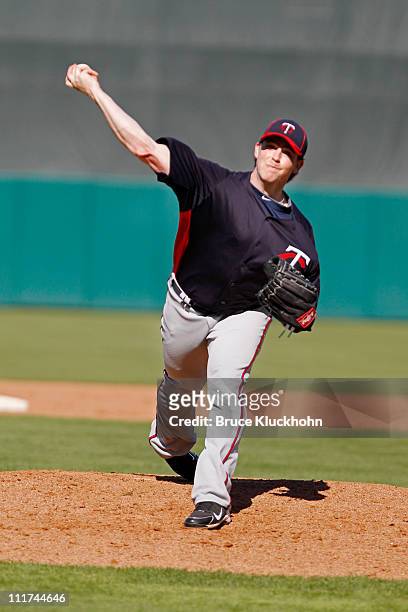 Eric Hacker of the Minnesota Twins warms up to pitch to the Boston Red Sox at a Spring Training game February 28, 2011 at City of Palms Park in Fort...