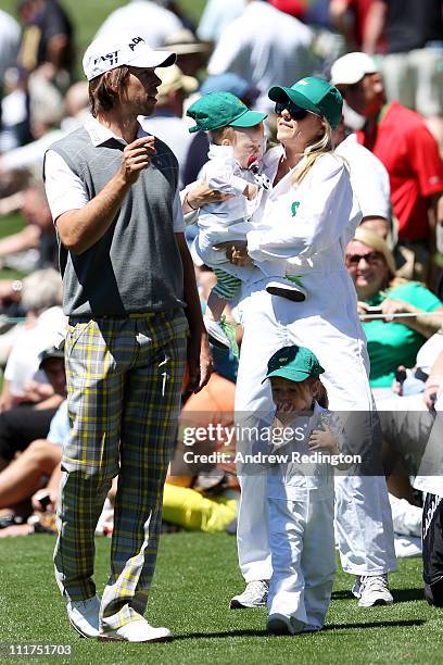 Aaron Baddeley of Australia chats with his wife Richelle and daughters Jewell and Jolee during the Par 3 Contest prior to the 2011 Masters Tournament...