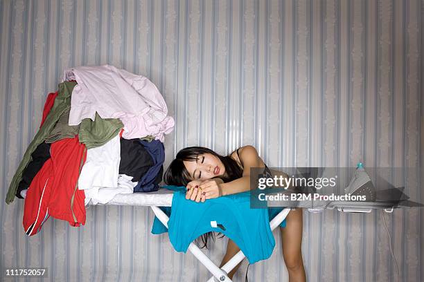 Woman Sleeping On Ironing Board, Foto de stock