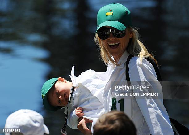 Richelle Baddeley, wife of Australian golfer Aaron Baddeley,walks with her daughter Jolee during the Par 3 Contest prior to the 2011 Masters...