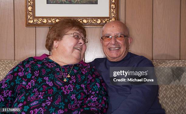 elderly man and woman sitting on couch - michael sit stock pictures, royalty-free photos & images