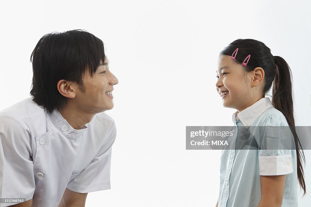 Girl Showing Teeth to Dentist