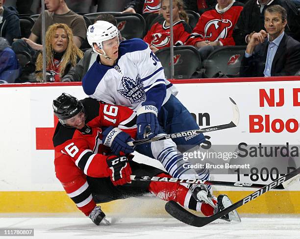 Jacob Josefson of the New Jersey Devils takes a two minute penalty for holding Carl Gunnarsson of the Toronto Maple Leafs at the Prudential Center on...