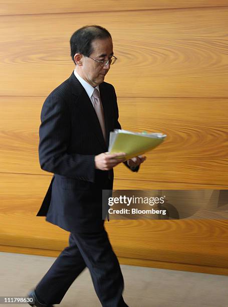 Masaaki Shirakawa, governor of the Bank of Japan, leaves a news conference at the central bank's headquarters in Tokyo, Japan, on Thursday, April 7,...