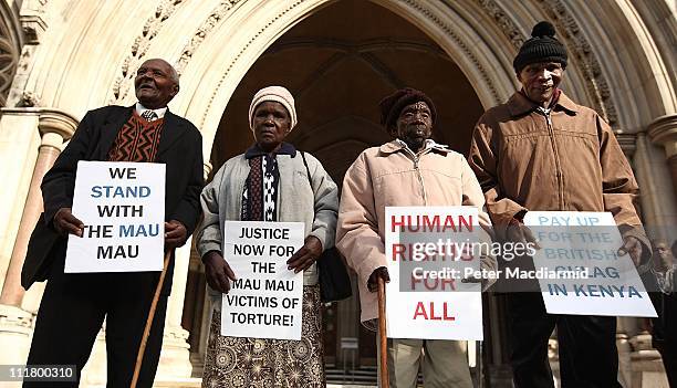 Kenyans Wambugu Wa Nyingi, Jane Muthoni, Paulo Nzili and Ndiku Mutua stand outside the High Court on April 7, 2011 in London, England. Four Kenyans...