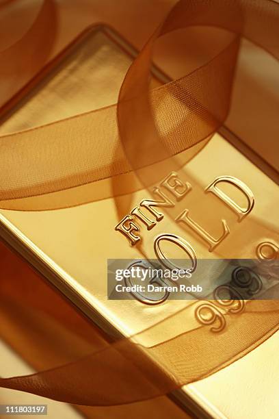 a gold bar with ribbon - metallic letters stock pictures, royalty-free photos & images