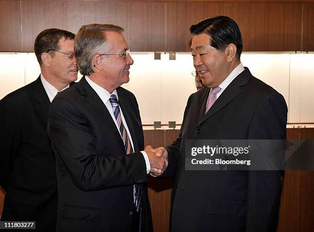 Wayne Swan, Australia's treasurer, left, shakes hands with Jia Qinglin, chairman of the Chinese People's Political Consultative Conference , before a...