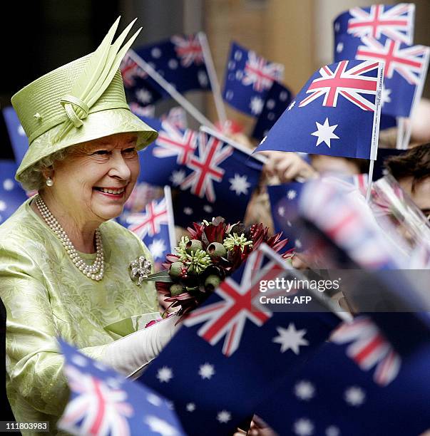Britain's Queen Elizabeth II , receives flowers from waiting school children waiving national flags after the Commonwealth Day Service in Sydney, 13...