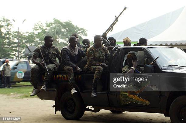 Internationally recognised leader Alassane Ouattara's FRCI soldiers ride an armed vehicle as they prepare at the Golf Hotel in Abidjan on April 3,...