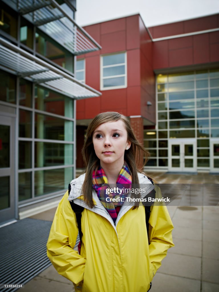 Young student standing outside of modern school