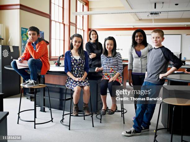 group of young students with teacher in classroom - inclusive classroom stockfoto's en -beelden