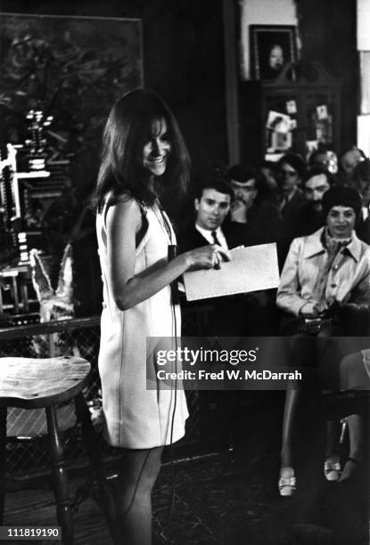 American poet Louise Gluck smiles as she reads her work to an audience in the home of authro Norman Mailer , New York, New York, May 24, 1968.
