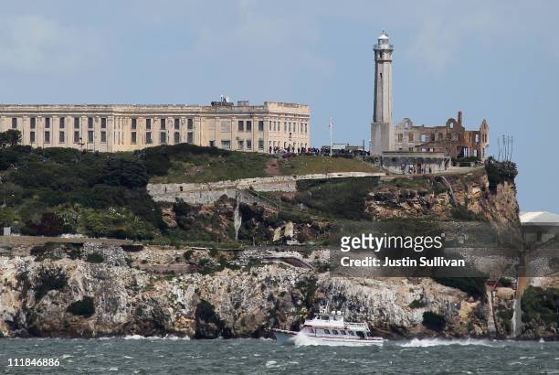 Boat passes Alcatraz Island on April 7, 2011 in San Francisco, United States. If the federal budget impasse cannot be resolved by the Friday...