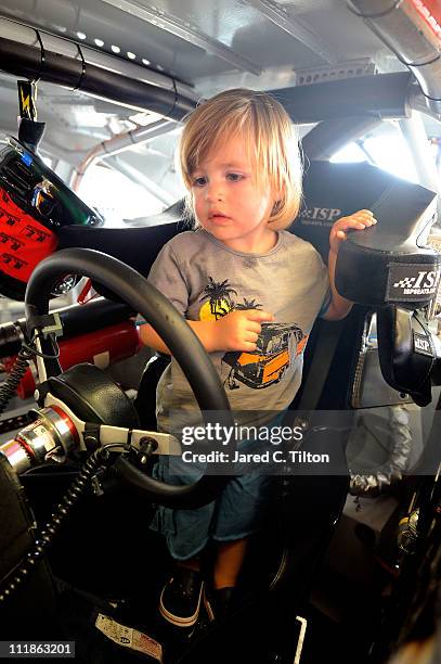 David Starr Jr., son of David Starr, driver of the Texas Farm and Ranch/31-W Insulation Chevrolet, stands in his father's car during practice for the...