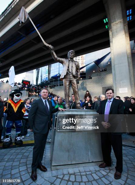 Canucks General Manager Mike Gillis stands with Canucks Owner Francesco Aquilini at the unveiling of a statue honouring former Canuck Coach Roger...