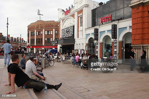 Members of the public enjoy a drink in the sunshine outside the Ritzy cinema in central Brixton on April 7, 2011 in London, England. The 1981 Brixton...