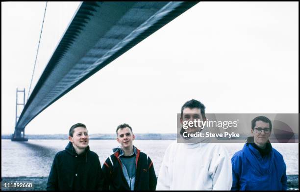 English pop group The Housemartins standing under the Humber Bridge, Kingston upon Hull, circa 1985. Left to right: Dave Hemingway, Norman Cook, Paul...