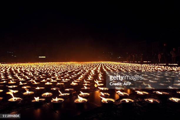 Hundreds out of 26,105 burning candles are pictured as Amnesty International established a new world record on June 4, 2008 representing the logo of...