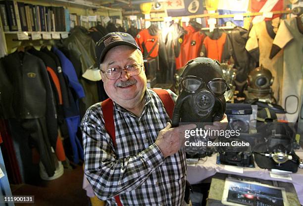 Paul Harling, with dive mask he made from a navy gas mask, in the Dive Locker, an exhibit of historical diving gear, at the Gloucester Maritime...
