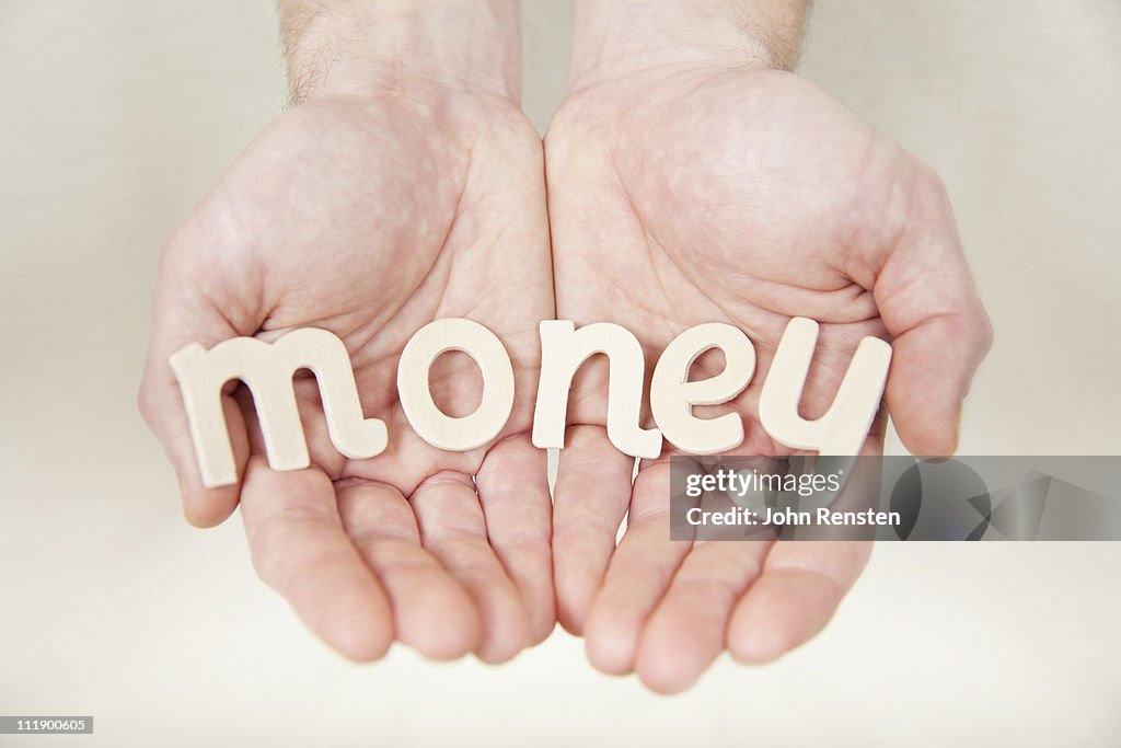 Hands holding letters spelling words