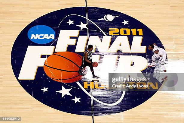 Shawn Vanzant of the Butler Bulldogs moves the ball up court against Donnell Beverly of the Connecticut Huskies during the National Championship Game...